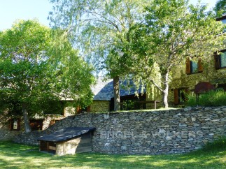 This charming stone house is nestled amongst lush greenery, offering a tranquil and picturesque setting.