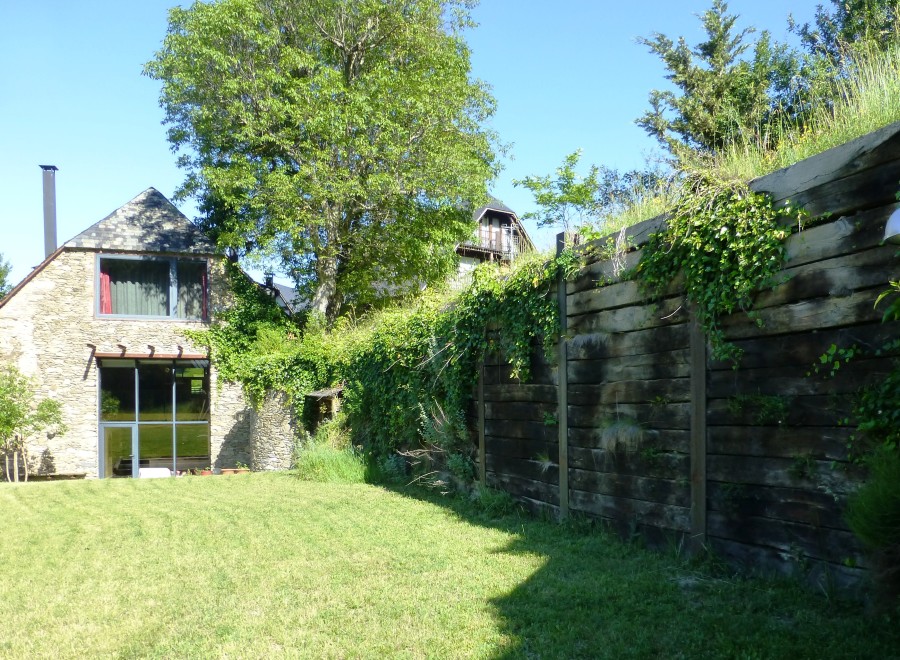 This charming stone house boasts a spacious lawn, perfect for outdoor relaxation.