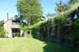 This charming stone house boasts a spacious lawn, perfect for outdoor relaxation.