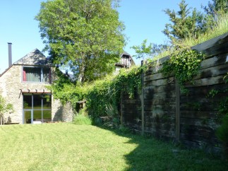 This charming stone house boasts a spacious lawn, perfect for outdoor relaxation.