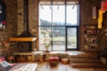Rustic mountain retreat with floor-to-ceiling windows offering breathtaking views.