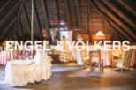 Charming attic space with exposed wooden beams and antique furnishings.