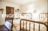 Charming country bedroom with twin beds and rustic wooden furniture.