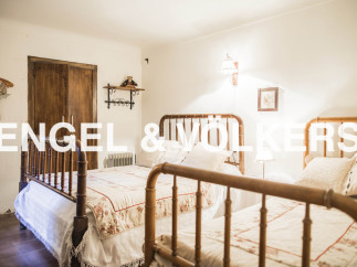 Charming country bedroom with twin beds and rustic wooden furniture.