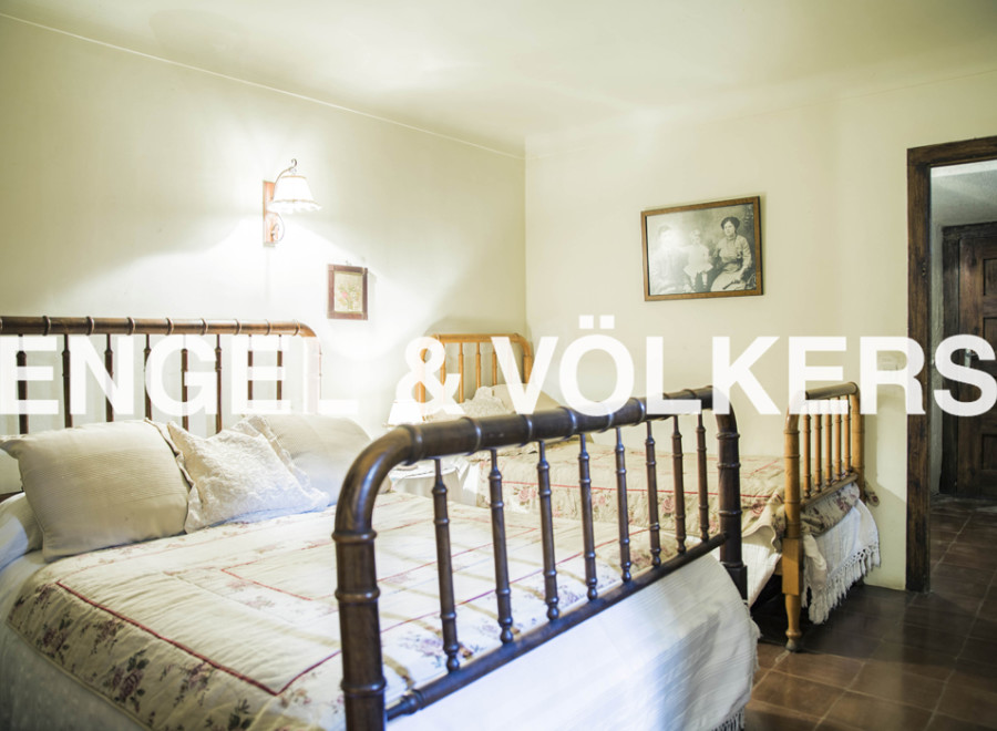 Charming bedroom with antique wooden beds and delicate bedding.