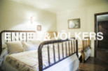Charming bedroom with antique wooden beds and delicate bedding.