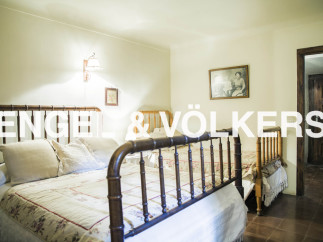 Charming bedroom with antique wooden beds and delicate bedding.