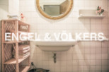Charming bathroom with pink accents and vintage details.