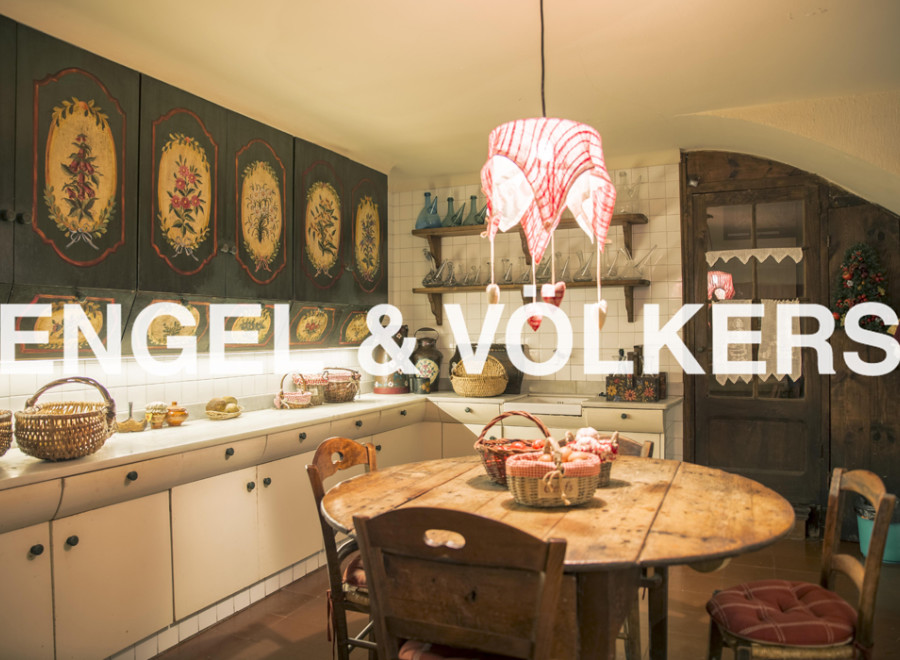 Charming kitchen with hand-painted cabinetry and a rustic wooden table.