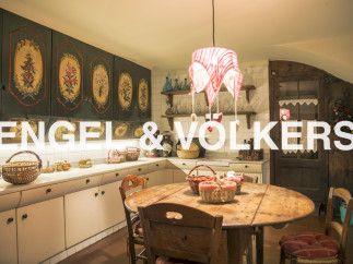Charming kitchen with hand-painted cabinetry and a rustic wooden table.
