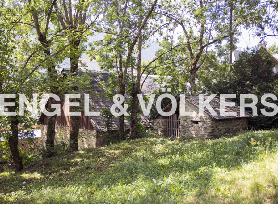 Discover this charming stone cottage nestled amidst lush greenery and mature trees.