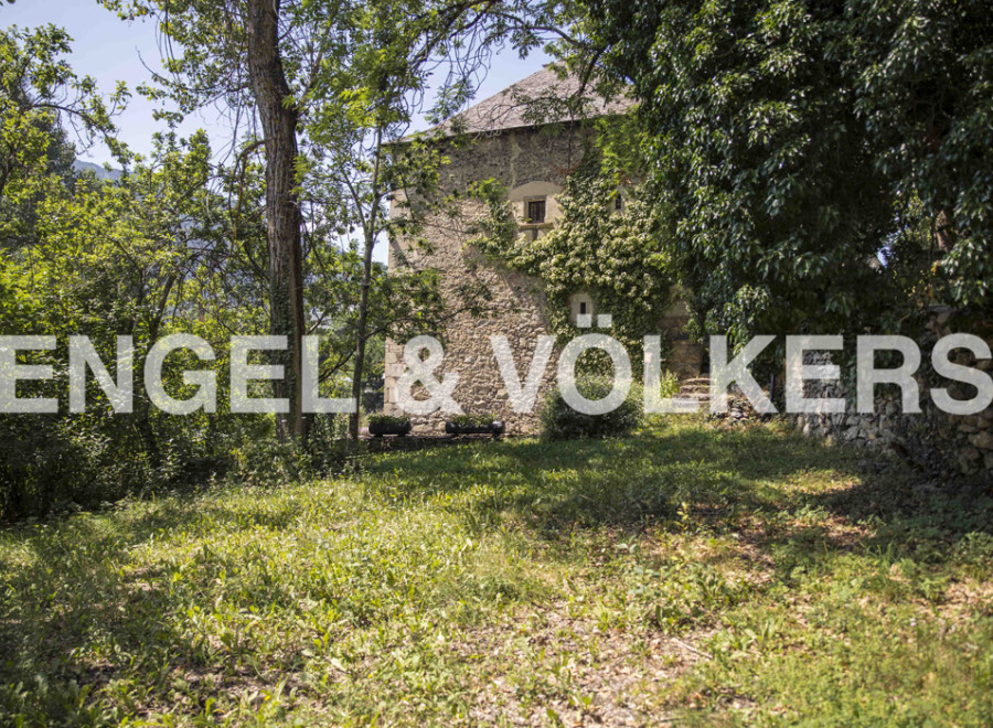 Discover this charming stone house nestled amidst lush greenery, offering a tranquil escape.