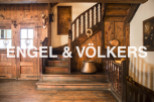 This stunning property boasts a grand wooden staircase, antique copper cookware, and unique wooden wall paneling.