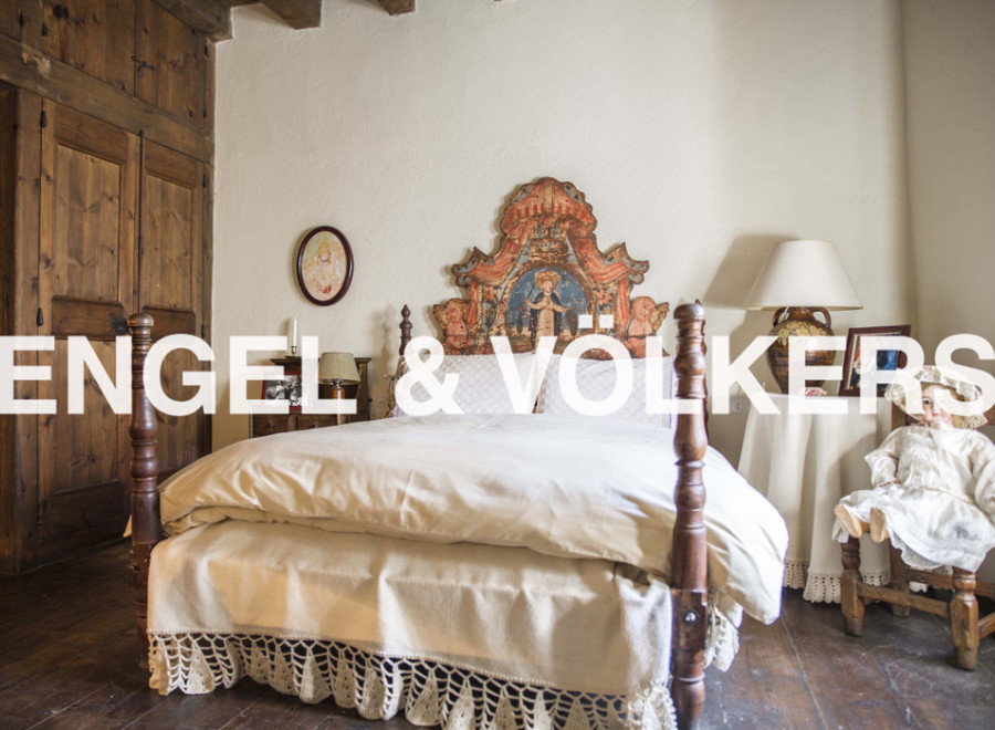 Charming bedroom with antique wooden bed and hand-painted headboard.
