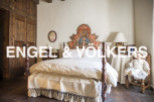 Charming bedroom with antique wooden bed and hand-painted headboard.