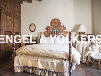 Charming bedroom with antique wooden bed and hand-painted headboard.