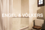 Rustic bathroom with vintage charm, featuring a bathtub, toilet, and shower curtain.