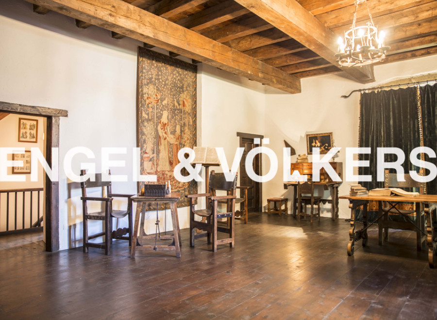 This stunning property boasts a spacious interior with exposed wooden beams and hardwood floors.