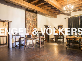 This stunning property boasts a spacious interior with exposed wooden beams and hardwood floors.