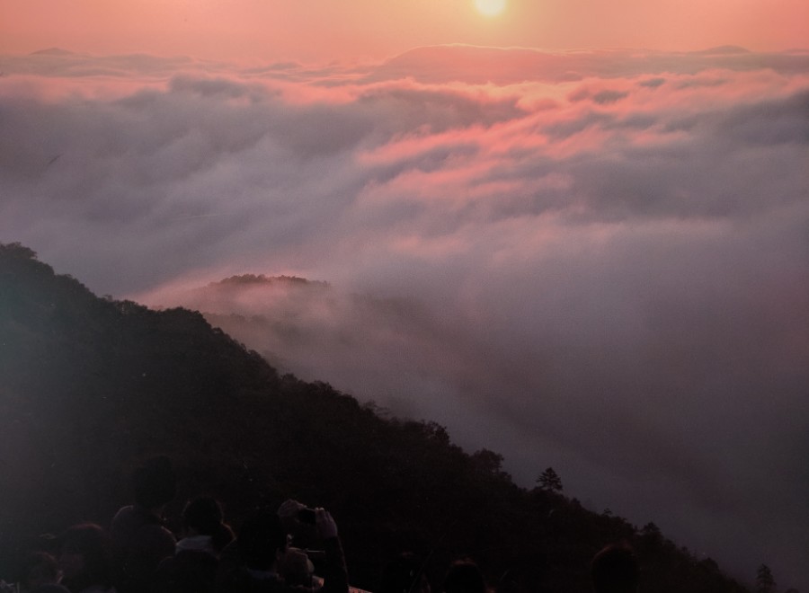 Witness a breathtaking sunrise over a sea of clouds.