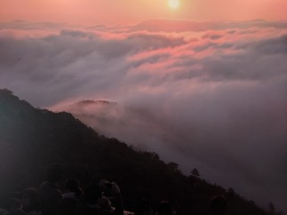 Witness a breathtaking sunrise over a sea of clouds.