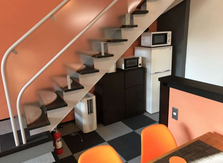This cozy apartment features a unique design with a staircase leading to the upper level.