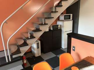 This cozy apartment features a unique design with a staircase leading to the upper level.