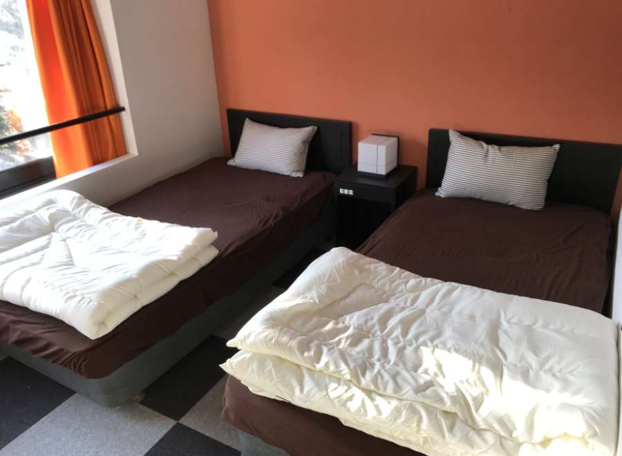 Cozy bedroom with two twin beds, perfect for a comfortable stay.