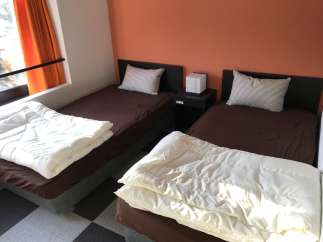 Cozy bedroom with two twin beds, perfect for a comfortable stay.