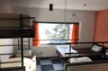 This cozy hostel room features bunk beds and individual beds, perfect for budget travelers.