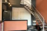 This property features a modern interior with a unique staircase design.
