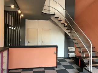 This property features a modern interior with a unique staircase design.