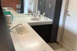Modern and stylish kitchen with sleek countertops and a built-in cooktop.