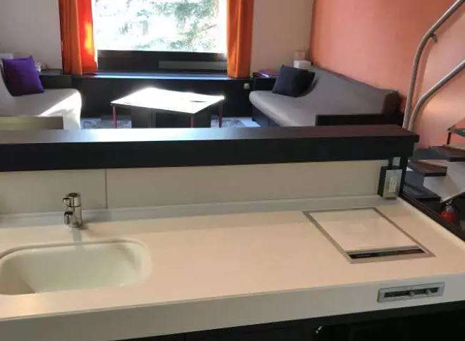 This modern property boasts a sleek kitchenette, perfect for preparing meals.