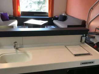 This modern property boasts a sleek kitchenette, perfect for preparing meals.