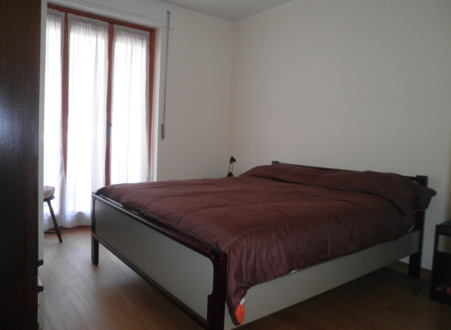 Cozy bedroom with a comfortable bed and a large window that lets in plenty of natural light.