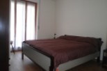 Cozy bedroom with a comfortable bed and a large window that lets in plenty of natural light.