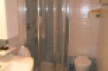 This bathroom features a modern shower with a glass enclosure, perfect for a refreshing start to your day.