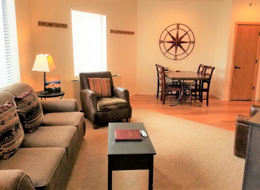 This cozy living space features a comfortable sofa with decorative pillows, perfect for relaxing.