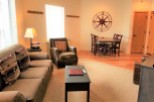 This cozy living space features a comfortable sofa with decorative pillows, perfect for relaxing.