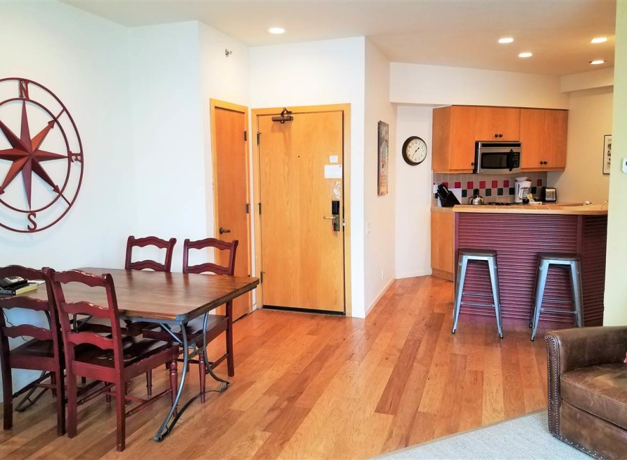 Discover this charming property featuring a cozy dining area with a stylish wooden table and chairs.