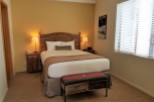 Cozy up in this inviting hotel room, featuring a comfortable bed and warm lighting.