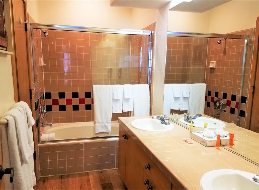 This bathroom features a classic design with tiled walls and a bathtub-shower combo.