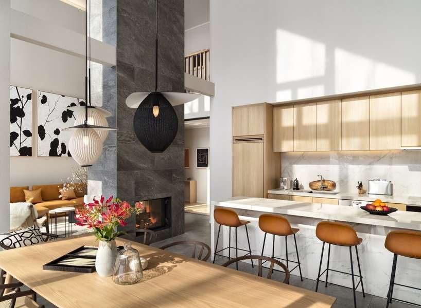 This stunning home boasts an open-concept living space with a double-height ceiling, creating an airy and spacious atmosphere.