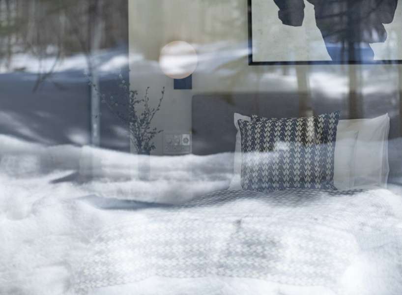 Cozy bedroom with a view: Wake up to stunning winter landscapes from the comfort of this inviting room.