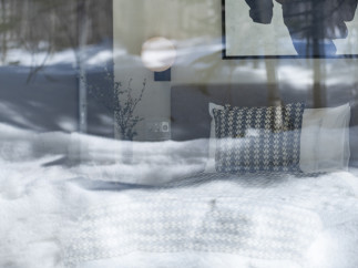 Cozy bedroom with a view: Wake up to stunning winter landscapes from the comfort of this inviting room.