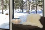 Cozy up by the window with a sheepskin throw and enjoy the snowy winter view.