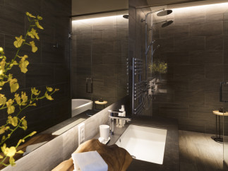 Luxurious bathroom with dark tile, a spacious shower with multiple shower heads, and a modern soaking tub.