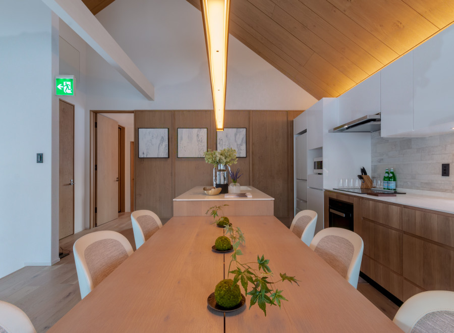 This stunning property boasts a spacious, light-filled dining area with a long wooden table perfect for gatherings.