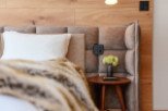 This luxurious bedroom boasts a plush upholstered headboard with built-in lighting and power outlets for ultimate convenience.